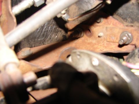 1973 Ford Ranchero - Close-up view of rusted metal components and wiring, likely from a vehicle's undercarriage.