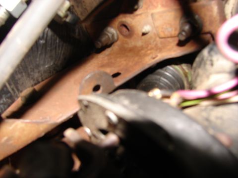 1973 Ford Ranchero - Undercarriage view showing a rusty bracket and some hoses, with no clear year identification.
