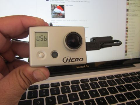 1968 Ford Mustang - A GoPro HERO camera is held in front of a laptop screen displaying a social media feed.