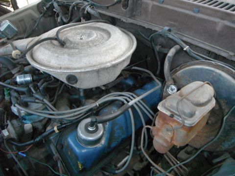 1979 Ford Bronco - Close-up view of an engine bay, the air cleaner and brake master cylinder.
