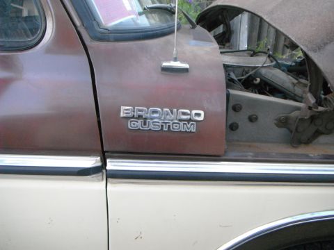 1979 Ford Bronco - Close-up of a Ford Bronco Custom fender and engine bay, revealing its mechanical details.