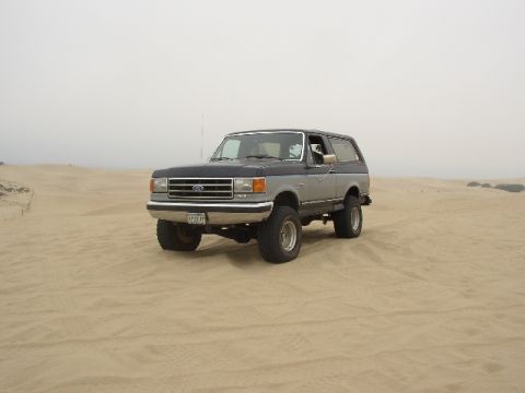 1989 Ford Bronco - This lifted 1989 Ford Bronco is shown off-roading in a sandy environment.