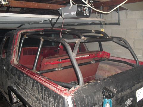 1986 Ford Bronco - Rear view of a 1986 Ford Bronco showing the interior and a custom roll cage.
