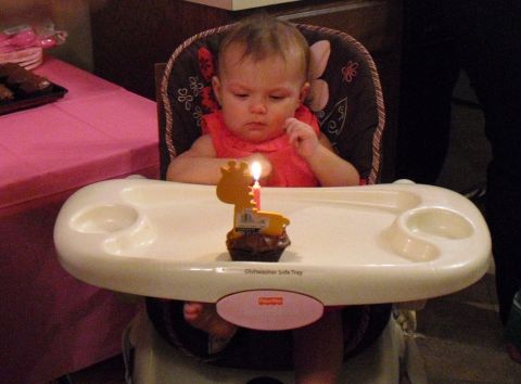 1986 Ford Bronco - A baby sits in a high chair with a cupcake and a single lit candle.
