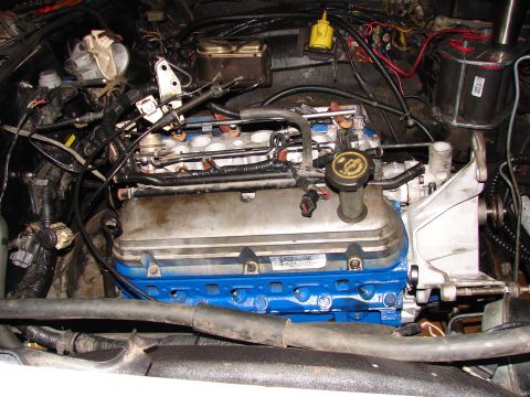 1973 Ford Ranchero - Close-up view of an engine bay, a blue-painted engine block and numerous mechanical components.