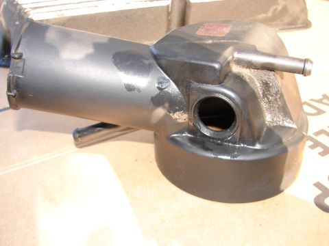 1973 Ford Ranchero - A close-up view of a used radiator overflow tank, showing some wear and tear.