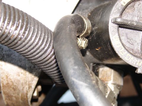 1973 Ford Ranchero - Close-up of engine components, including a hose and a cap with visible text.