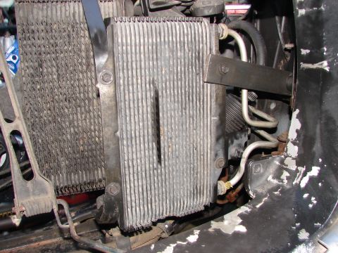 1973 Ford Ranchero - Close-up view of a transmission cooler and radiator assembly, showing hoses and mounting hardware.