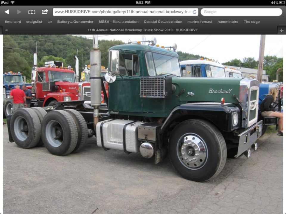 Green and black Brockway day-cab semi tractor at a truck show, 3/4 front view