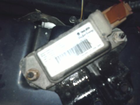 2001 Ford Crown Victoria - Close-up of an automotive sensor module, likely for an airbag system.