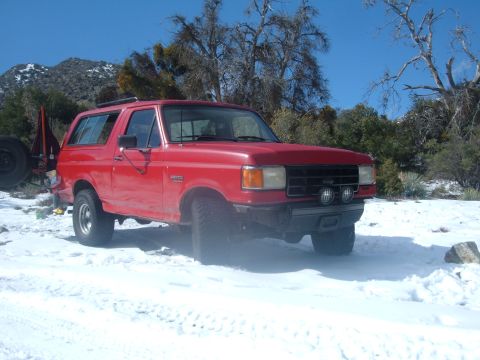 1988 Ford Bronco - 1988 Ford Bronco in a snowy, mountainous landscape.