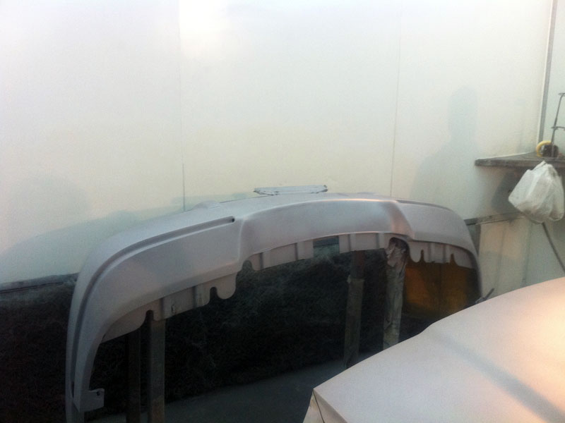 Gray primer front bumper on stand