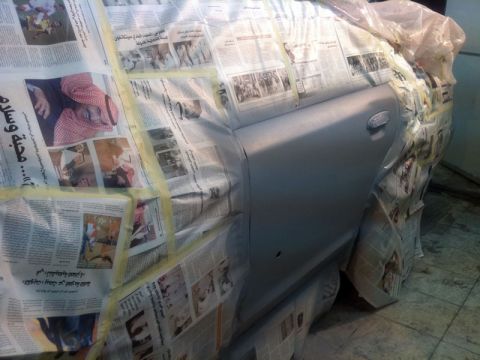 2001 Mercury Grand Marquis - Car body panels are masked with newspaper and tape before painting.