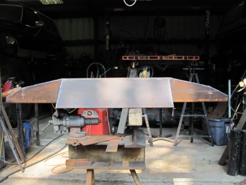 1982 Ford F-100 - Custom bumper fabrication in progress, clamped in a vise for welding and shaping.