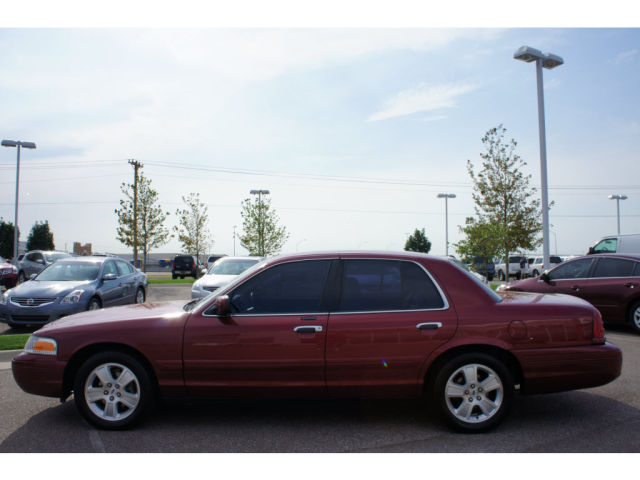 Red 2003 Ford Crown Victoria sedan, side view