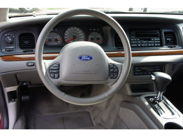 2003 Ford Crown Victoria interior with wood trim and Ford steering wheel