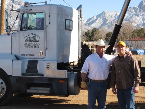 1995 Ford Bronco - Two men pose for a photo in front of a semi-truck, with mountains in the background.