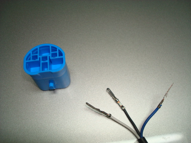 Blue electrical connector with three wires attached