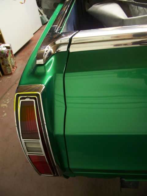 1971 Ford Ranchero - Rear view of a green 1971 Ford Ranchero, highlighting its chrome trim and taillight assembly.