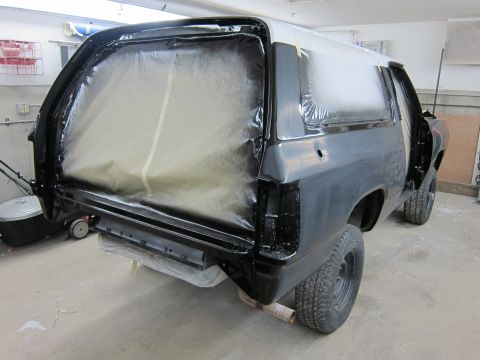 1987 Dodge 1500 - A Dodge Ramcharger is being prepped for painting, with its rear section covered in protective sheeting.