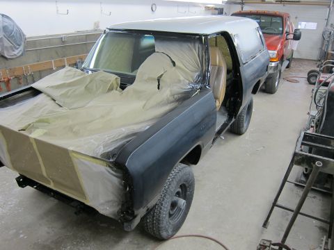 1987 Dodge 1500 - An SUV is being prepped for painting in a workshop, with another truck visible in the background.