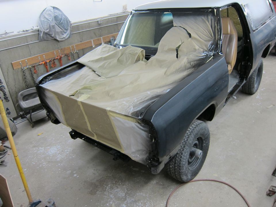1987 Dodge 1500 truck in body shop, hood and fenders taped off for paint