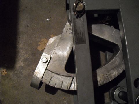 1986 Ford Bronco - A metal angle finder tool is shown resting on a concrete floor with some debris nearby.