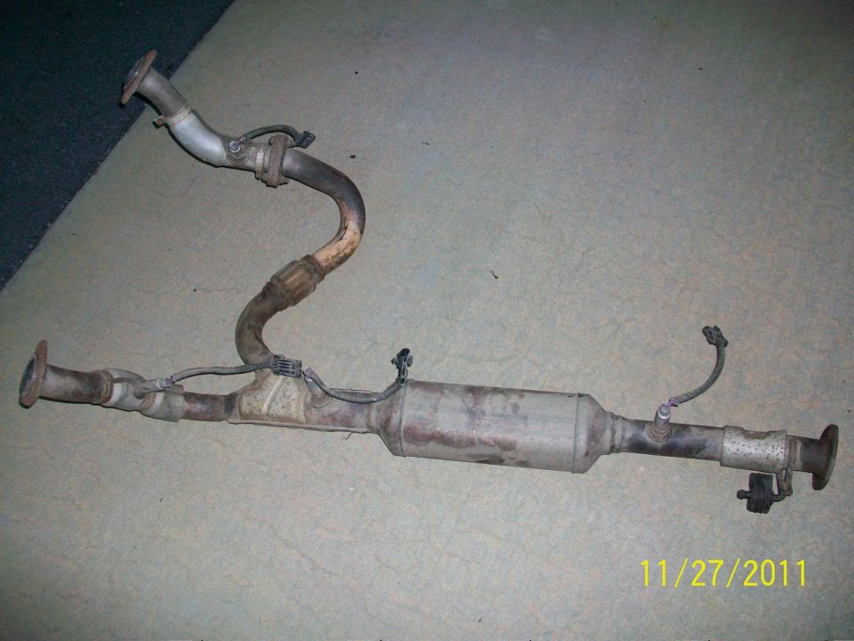 Exhaust system catalytic converter with pipes and sensors, dusty and metallic
