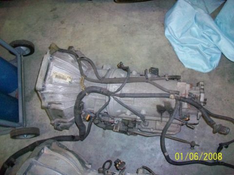 2000 Isuzu Vehicross - Transmission with GM label and wiring harness on concrete floor, dated 01/06/2008.