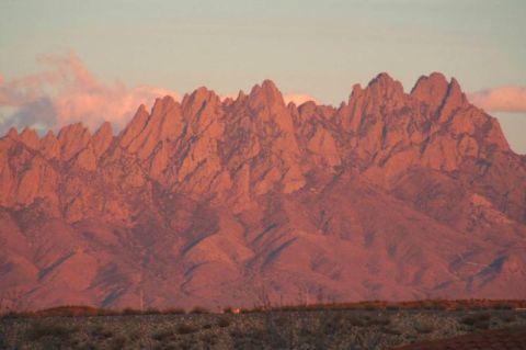 1995 Ford Bronco - The Organ Mountains are illuminated by the setting sun, casting a warm glow on the peaks.