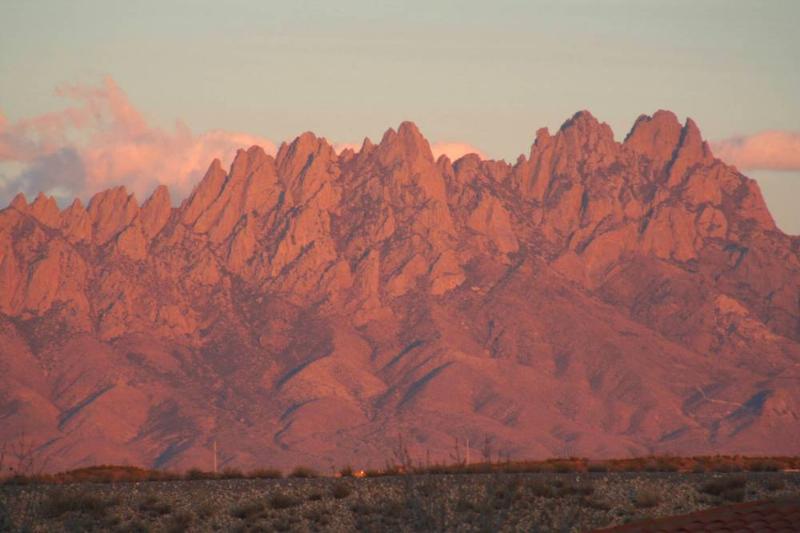 Desert landscape with jagged mountains at sunset