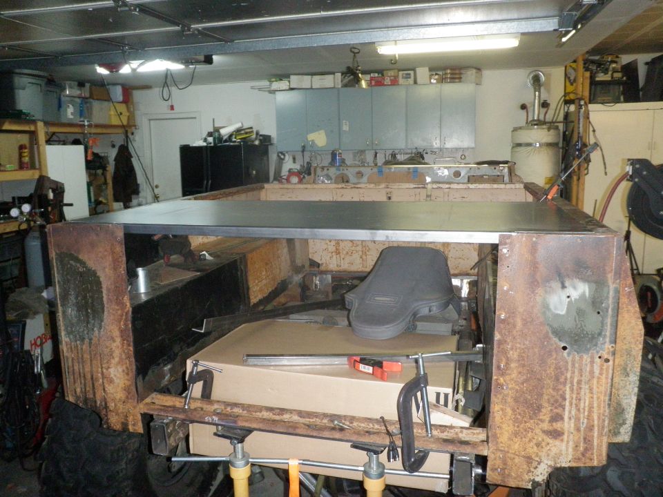 Interior of a vehicle under construction with a new metal floor being installed