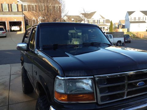 1995 Ford Bronco - Black 1995 Ford Bronco parked in a suburban driveway.