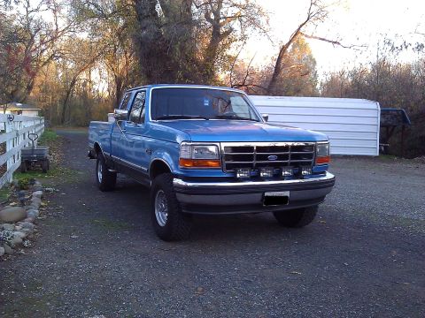 1992 Ford F-150 - This blue 1992 Ford F-150 pickup truck is shown from a 3q-front angle.