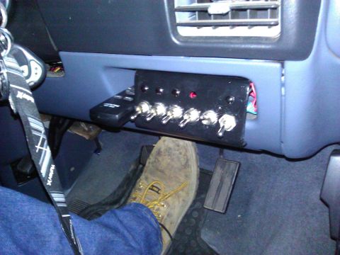 1992 Ford F-150 - Custom switch panel and remote control installed in the dashboard of a vehicle.
