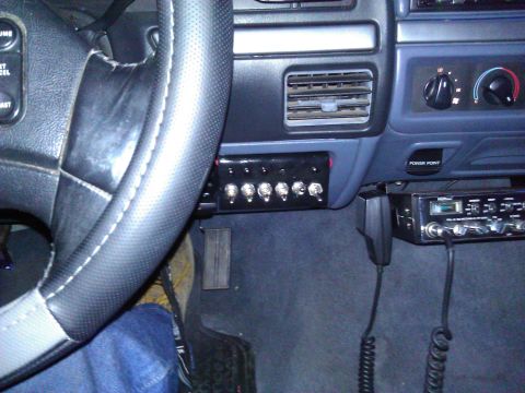 1992 Ford F-150 - The dashboard features a CB radio and a panel of auxiliary switches, along with the steering wheel and air vents.