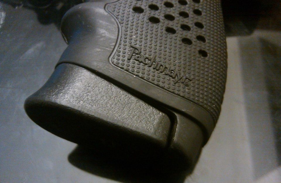 Black textured gun grip with 'Pachmayr' text, close-up