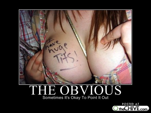 Woman's chest with 'I have huge Tits!' written on it