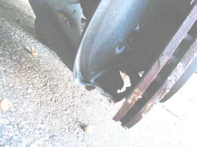1997 Ford Taurus - Close-up of a worn brake rotor and caliper, likely needing replacement.