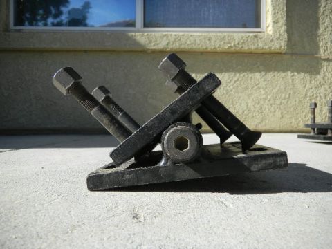 1997 Ford Ranger - A black metal part with bolts is shown in a close-up view.