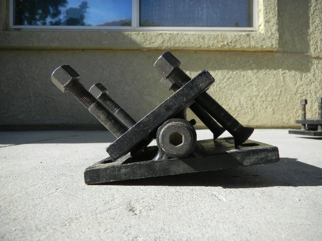 Black metal part with bolts