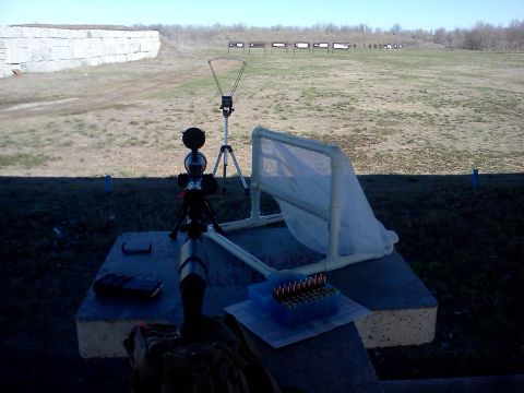 1996 Ford Bronco - A shooting range is set up with targets in the distance and equipment in the foreground, including a chronograph and a rifle scope.