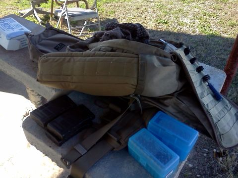 1996 Ford Bronco - A dog rests on a tactical bag next to ammunition and magazines, suggesting preparation for outdoor activities.