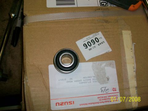 2000 Isuzu Vehicross - A single bearing rests on a cardboard box with shipping labels, including one with the Isuzu logo.