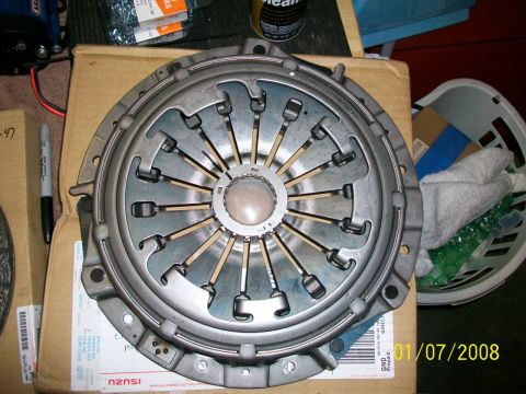 2000 Isuzu Vehicross - A clutch pressure plate is shown, with part numbers and a date stamp of 01/07/2008 visible on the packaging.