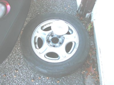 1997 Ford Taurus - A single tire and wheel assembly is visible, with a white disc placed on the wheel's center.