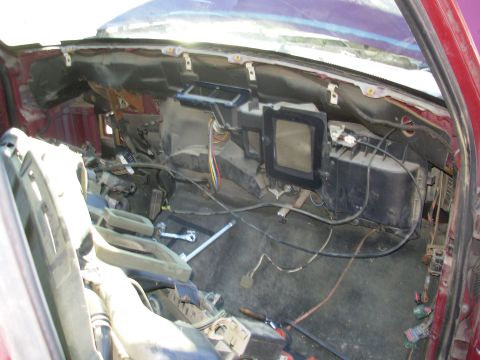 1983 Ford Bronco - Dash coming out. The white clips across the top of the firewall hold the driver's door harness.