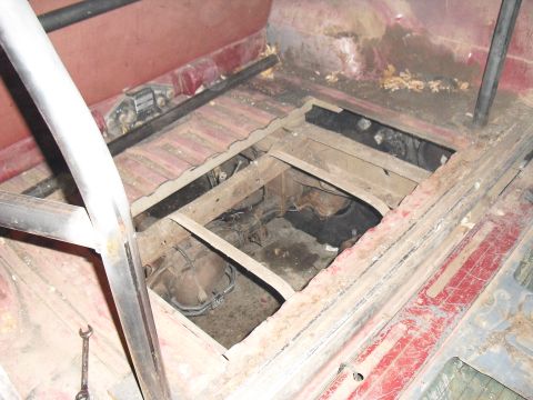 1986 Ford Bronco - The floor of this vehicle has been opened up to expose the transmission and other mechanical parts underneath.