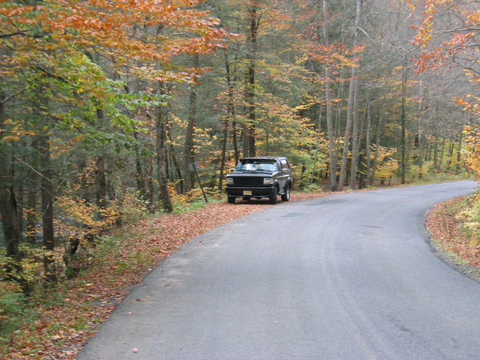 1994 Ford Bronco parked on a rural road during fall foliage