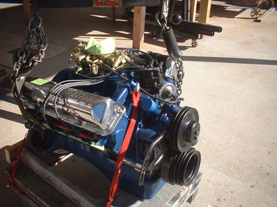 Blue V8 engine with chrome valve covers and carburetor